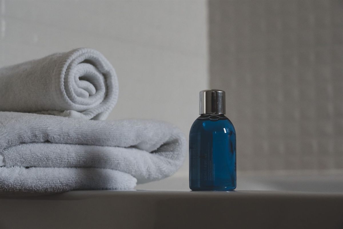 Clean folded towels beside a bottle — non-porous toys are simple to keep spotless