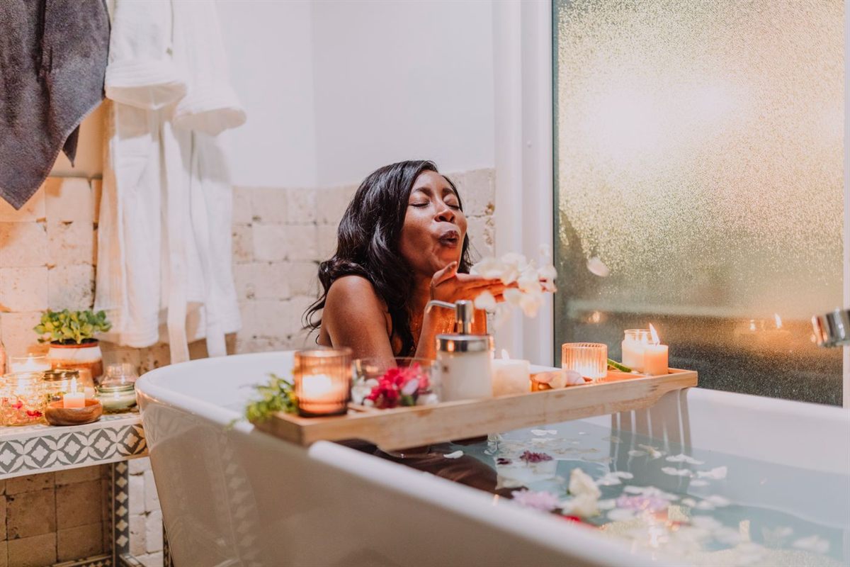 A warm, candlelit self-care moment — caring for your body inside and out