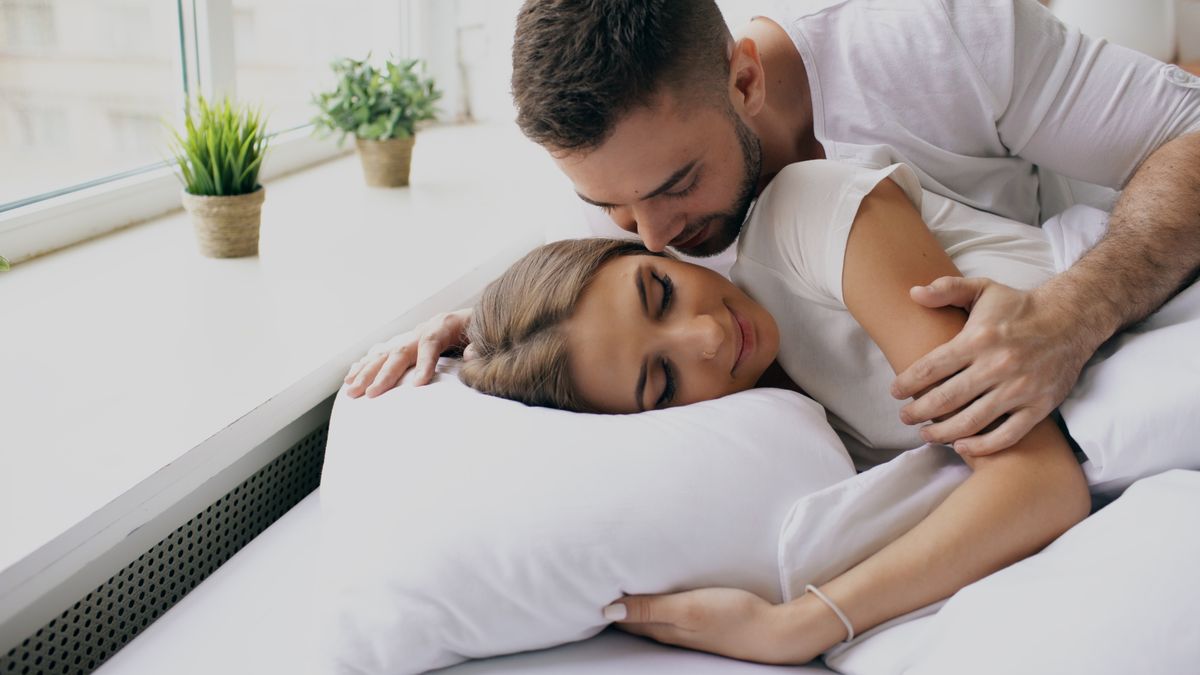 A couple resting close together in soft morning light, calm and connected